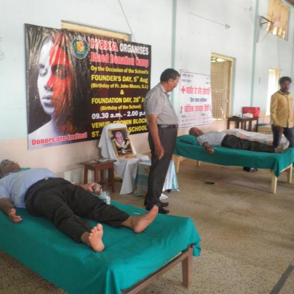 Fr. P.J.James s.j. and Mr. Cyprian Surin donating blood;
