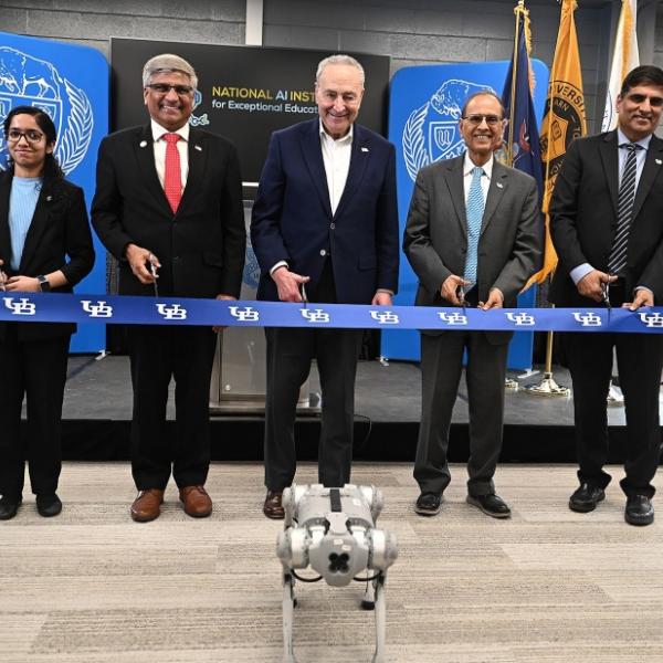 Preparing to cut the ribbon to open the National AI Institute for Exceptional Education are (from left) Sahana Rangasrinivasan, a computer science and engineering PhD candidate; NSF Director Sethuraman Panchanathan; U.S. Senate Majority Leader Chuck Schumer; President Satish K. Tripathi and Venu Govindaraju, vice president for research and economic development, and principal investigator of the AI institute. Photo: Nancy J. Parisi